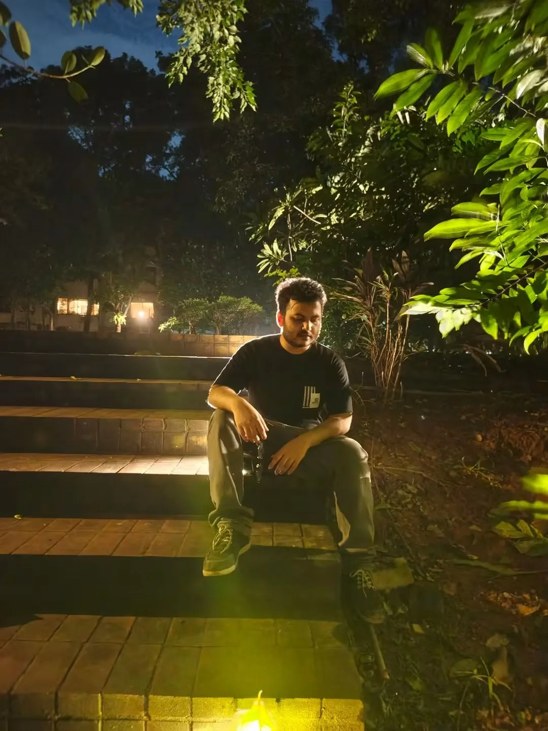 Asif Rezan seated in a garden during an evening portrait session