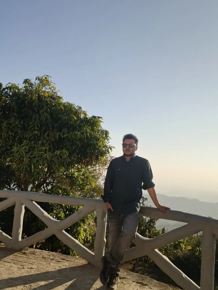 Bangladeshi man Asif Rezan posing at a scenic hill viewpoint
