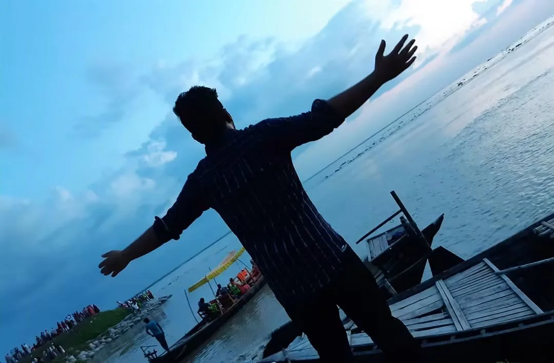 Silhouette of Asif Rezan beside a river in Bangladesh